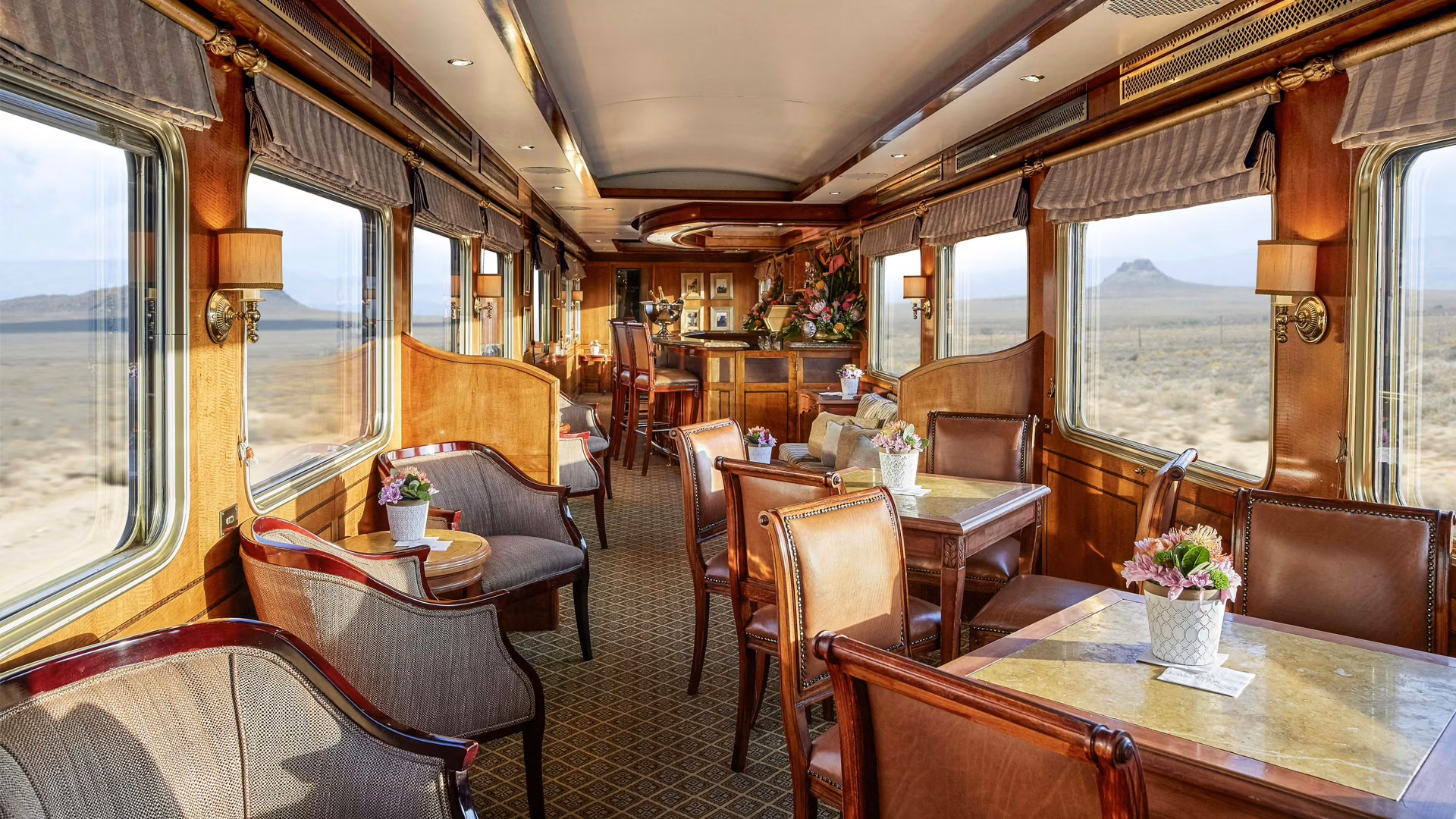 The lounge and bar carriage on the luxury Blue Train as it passes through the empty landscape of the Karoo, South Africa