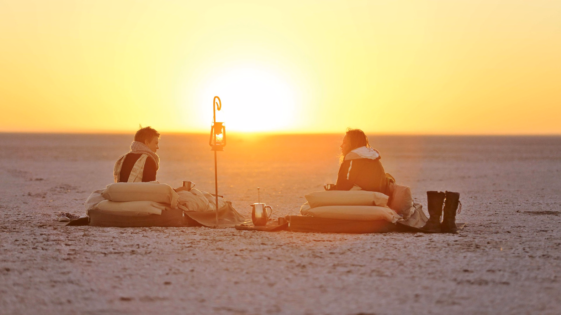 Dramatic sunset shot of the Kubu Island Fly Camp on the salt pans. An expereince offered by the best African safari operators at Sunset, Makgadikgadi Pans, Botswana