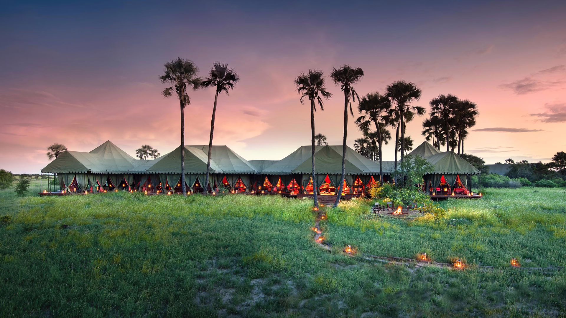 Jack's Camp surrounded by palm trees, a tented camp and unique African safari, Makgadikgadi Salt Pans, Botswana
