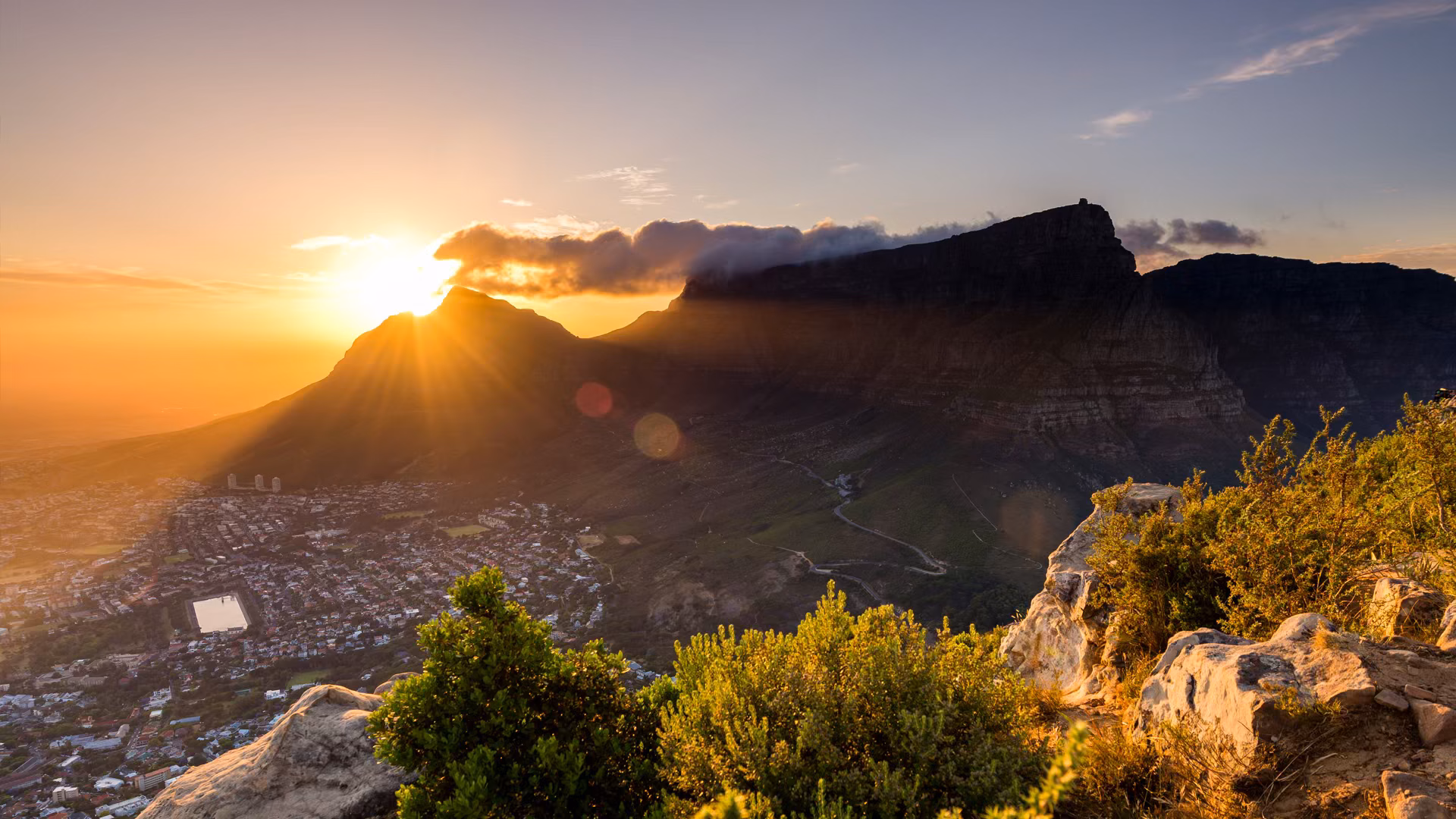 Luxury South Africa Safari and Victoria Falls. Sunrise over Table Mountain in Cape Town with view of the city below
