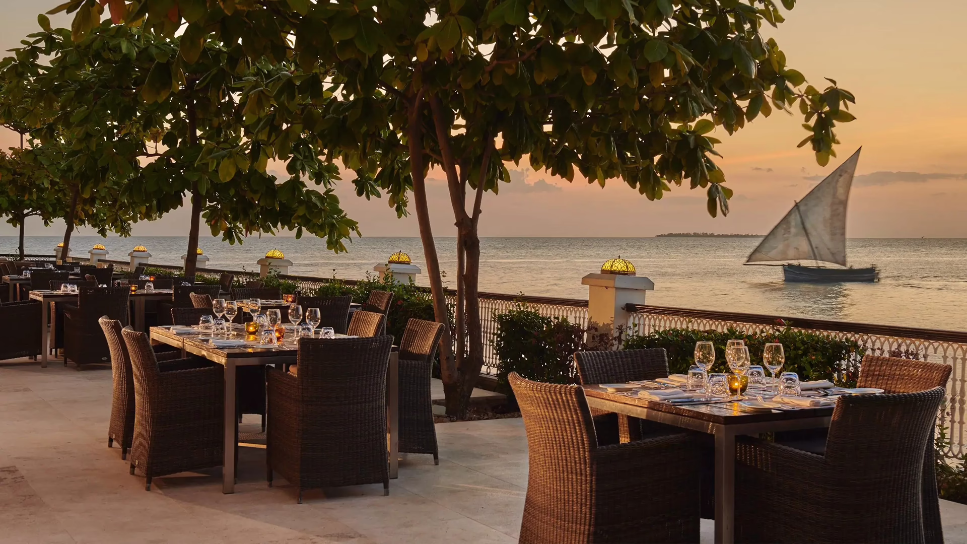 Outdoor dining terrace under a tree hung with lights at Park Hyatt Zanzibar